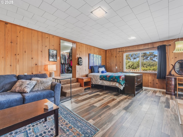 1749 NE 19th St, Lincoln City, OR 97367 - bedroom featuring wood finished floors, wooden walls, and a closet