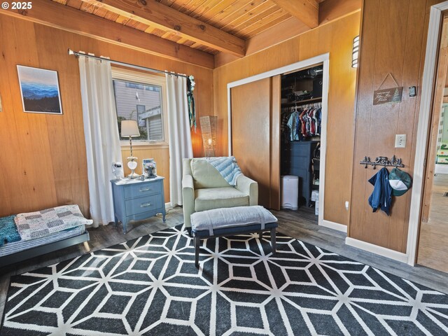1749 NE 19th St, Lincoln City, OR 97367 - living area featuring wood walls, wood ceiling with exposed beams, wood finished floors, and baseboards