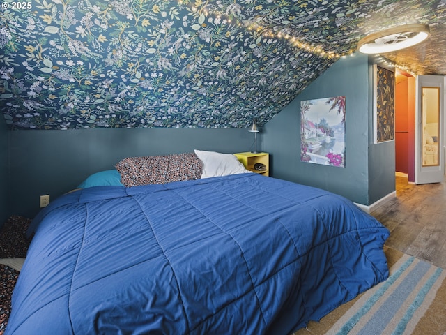 1749 NE 19th St, Lincoln City, OR 97367 - bedroom featuring wood finished floors, baseboards, and vaulted ceiling