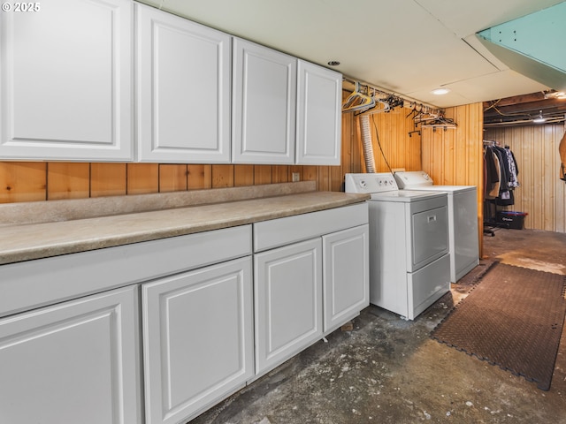 1749 NE 19th St, Lincoln City, OR 97367 - laundry area featuring separate washer and dryer, cabinet space, and wood walls