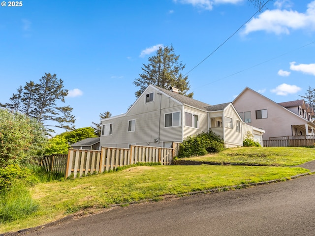 1749 NE 19th St, Lincoln City, OR 97367 - view of front facade featuring board and batten siding and a chimney