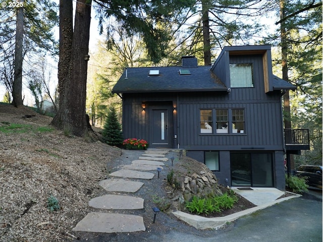 view of front of house featuring board and batten siding and a chimney