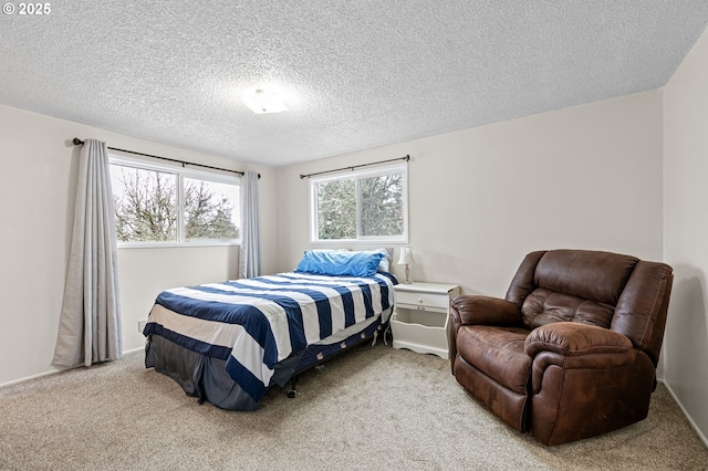 bedroom featuring light carpet and a textured ceiling