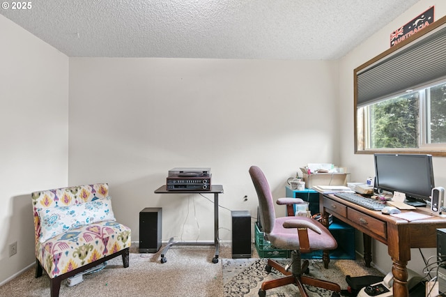 carpeted office space with a textured ceiling and baseboards