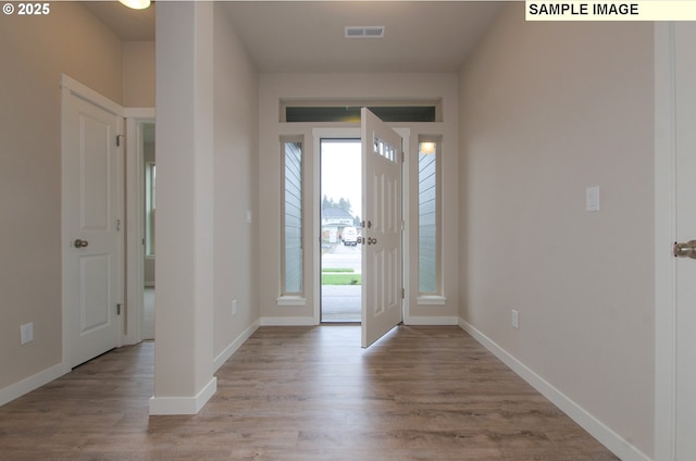 foyer entrance with light hardwood / wood-style floors