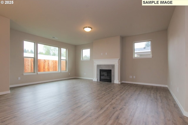 unfurnished living room featuring light hardwood / wood-style flooring and a fireplace