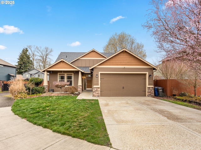 craftsman-style house with a front lawn, fence, roof with shingles, stone siding, and an attached garage