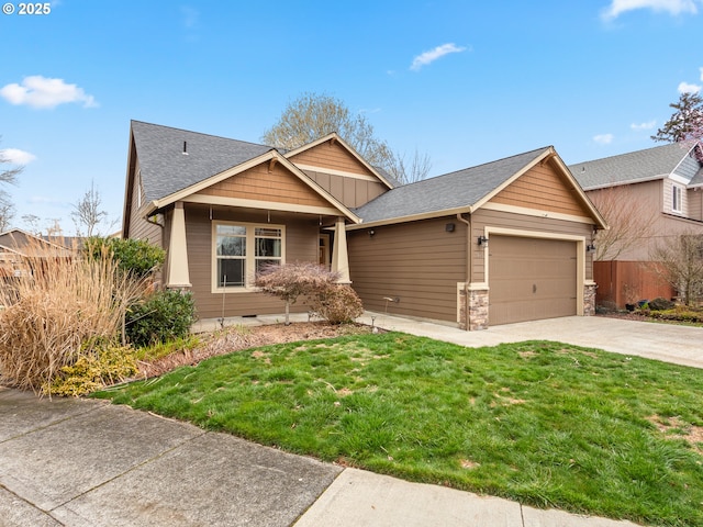 craftsman house with an attached garage, a shingled roof, driveway, and a front lawn