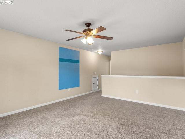 unfurnished room with baseboards, a ceiling fan, and carpet floors