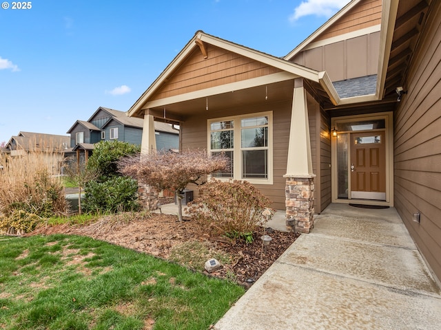 view of exterior entry with board and batten siding