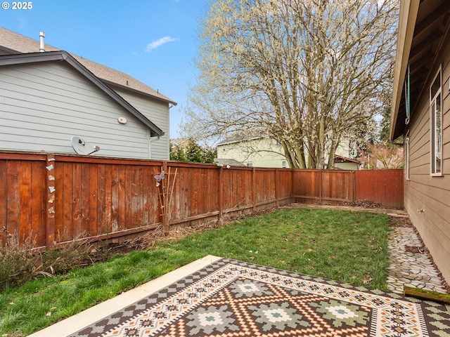 view of yard with a fenced backyard and a patio