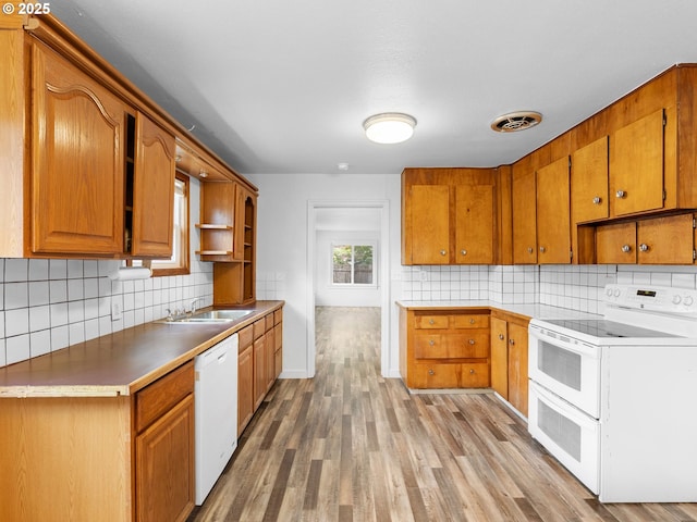 2745 SW 187th Ave, Beaverton, OR 97003 - kitchen featuring white appliances, open shelves, backsplash, light wood-style floors, and brown cabinetry