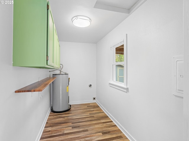 2745 SW 187th Ave, Beaverton, OR 97003 - laundry room featuring electric water heater, dark wood-style floors, attic access, and cabinet space