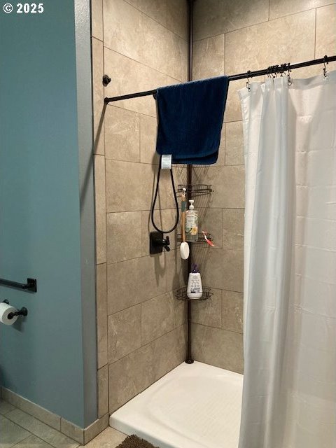 bathroom featuring tile patterned floors and curtained shower