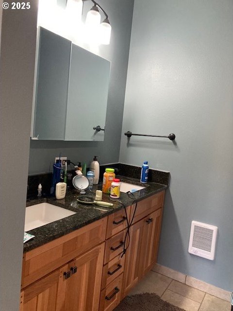 bathroom with tile patterned floors and vanity