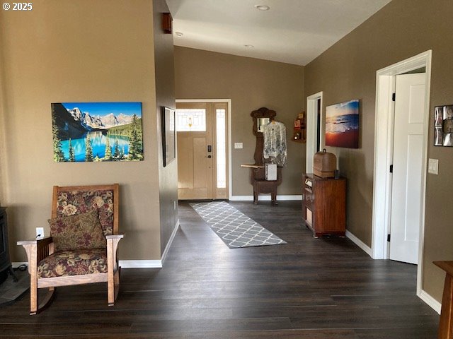 foyer featuring lofted ceiling and dark hardwood / wood-style floors