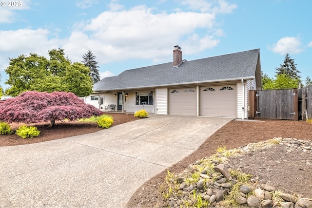 ranch-style home featuring driveway, a chimney, a garage, fence, and a shingled roof