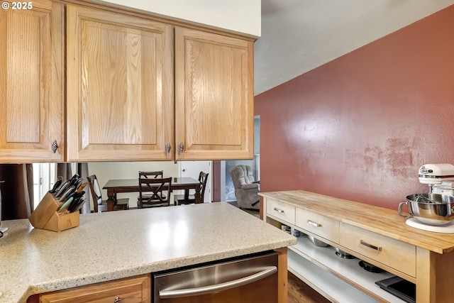 kitchen featuring light brown cabinetry and dishwasher