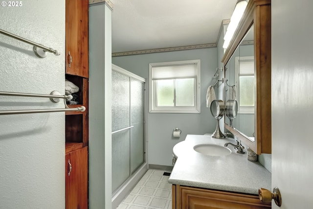 bathroom featuring tile patterned floors, a shower stall, and vanity