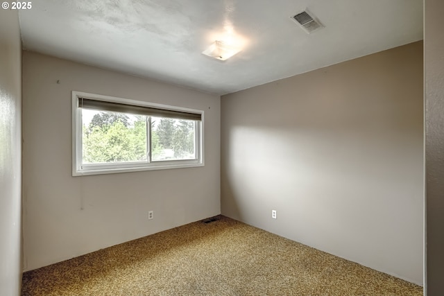 unfurnished room featuring carpet and visible vents