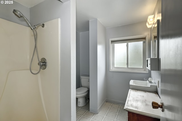 bathroom with vanity, walk in shower, tile patterned floors, and toilet
