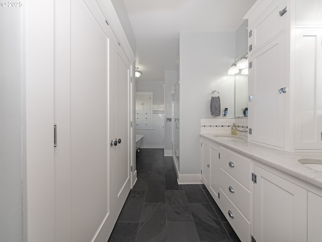 bathroom with tile patterned flooring, decorative backsplash, and vanity