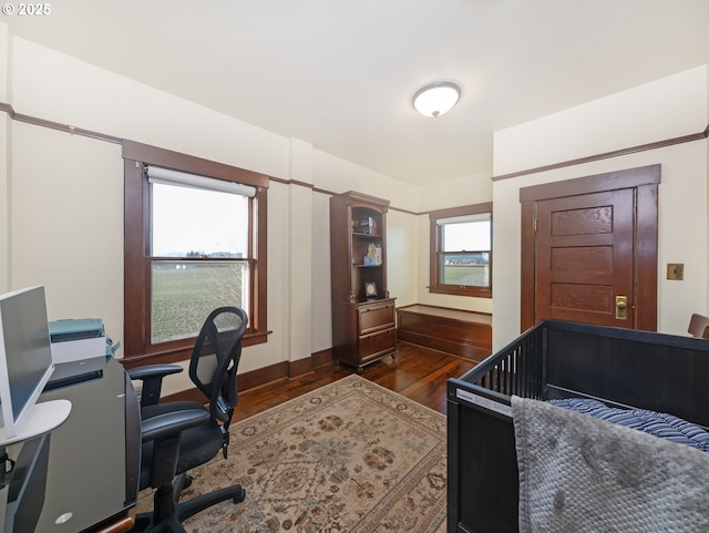 bedroom with dark hardwood / wood-style flooring