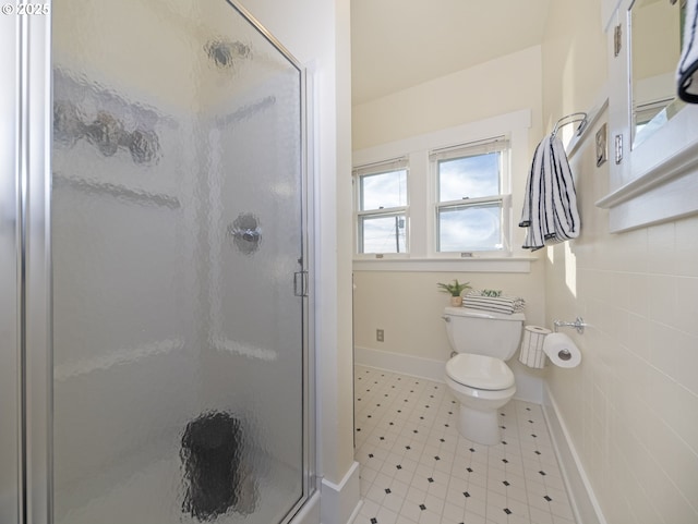 bathroom with toilet and an enclosed shower