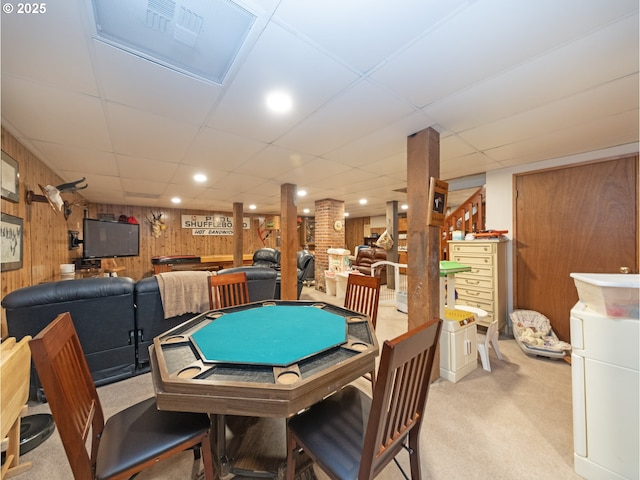 playroom with a drop ceiling, wooden walls, light carpet, and sink