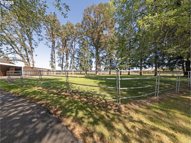 view of yard with a rural view and an outdoor structure