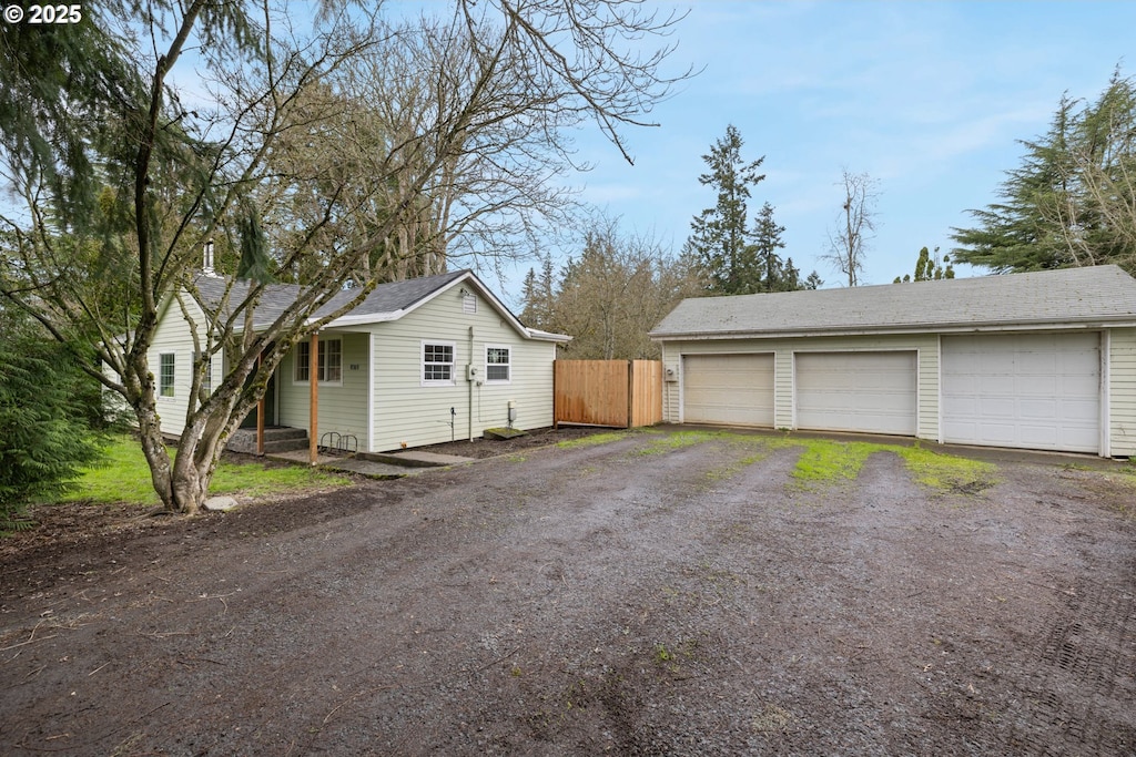 8381 S Vale Garden Rd, Canby, OR 97013 - view of home's exterior featuring an outbuilding, a garage, and fence