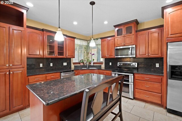 13845 SW Far Vista Dr, Beaverton, OR 97005 - kitchen with appliances with stainless steel finishes, a sink, light tile patterned floors, a kitchen breakfast bar, and decorative light fixtures