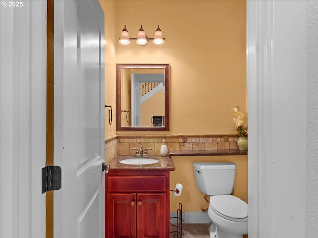 13845 SW Far Vista Dr, Beaverton, OR 97005 - bathroom featuring toilet, vanity, tile patterned flooring, and a wainscoted wall