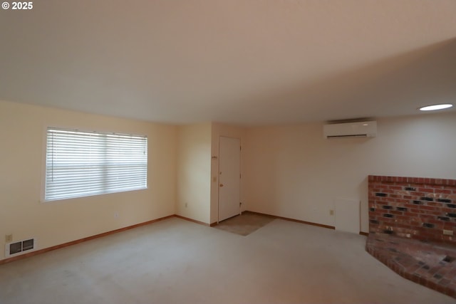 unfurnished living room featuring light colored carpet and a wall mounted AC