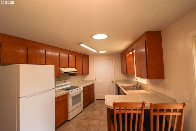 kitchen featuring sink, light tile patterned floors, tile counters, kitchen peninsula, and white appliances