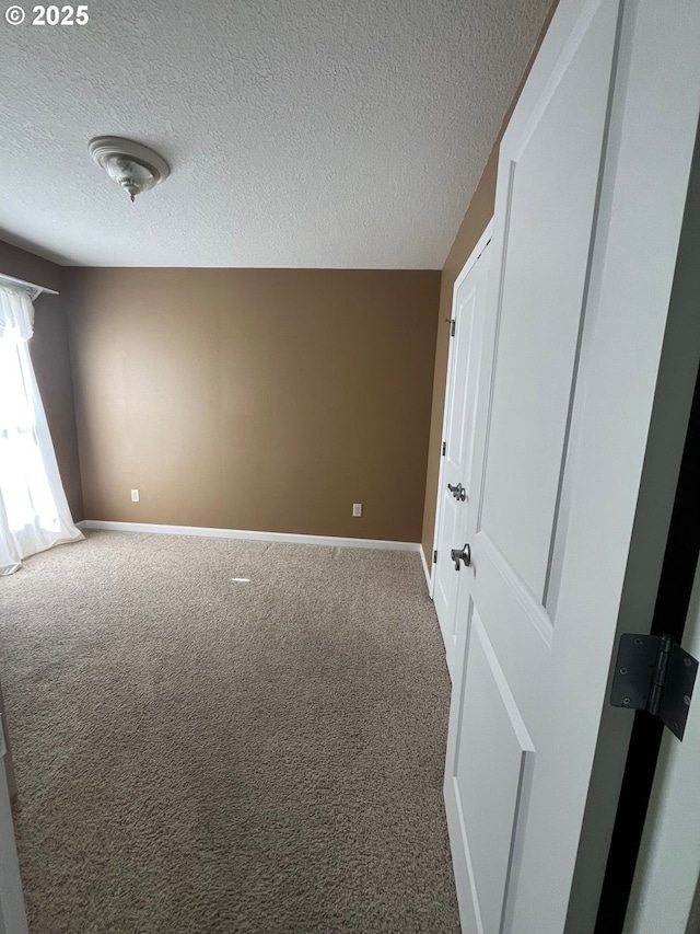 99 Rainbow Way, Kelso, WA 98626 - empty room featuring carpet, baseboards, and a textured ceiling
