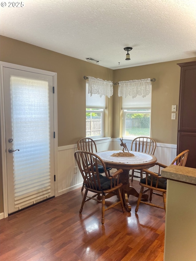 99 Rainbow Way, Kelso, WA 98626 - dining space with a wainscoted wall, a textured ceiling, and wood finished floors
