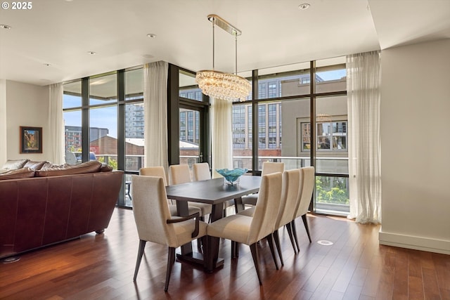 311 NW 12th Ave Unit 602, Portland, OR 97209 - dining area with plenty of natural light, floor to ceiling windows, a chandelier, dark wood finished floors, and baseboards