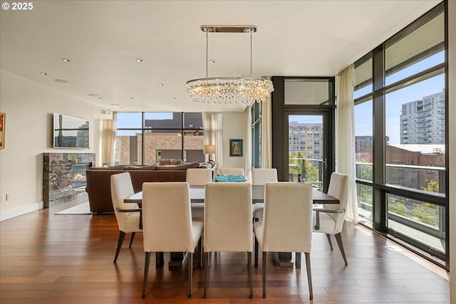 311 NW 12th Ave Unit 602, Portland, OR 97209 - dining area featuring expansive windows, a chandelier, healthy amount of natural light, a city view, and recessed lighting