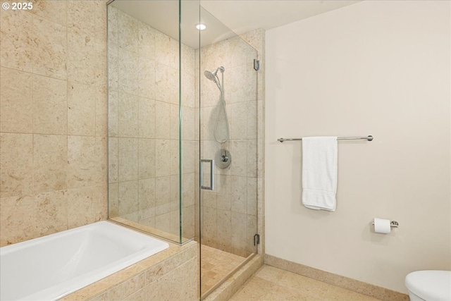 bathroom featuring a shower stall, a bath, baseboards, toilet, and tile patterned floors