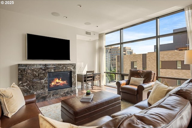 311 NW 12th Ave Unit 602, Portland, OR 97209 - living area featuring a wall of windows, wood finished floors, a fireplace, and plenty of natural light
