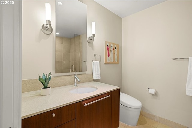 311 NW 12th Ave Unit 602, Portland, OR 97209 - bathroom with vanity, toilet, tile patterned floors, tiled shower, and baseboards