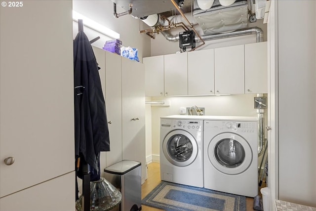 311 NW 12th Ave Unit 602, Portland, OR 97209 - washroom featuring washing machine and dryer and cabinet space