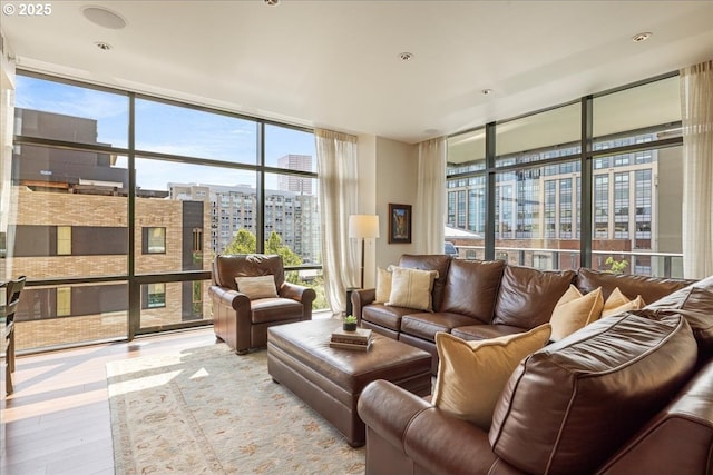 311 NW 12th Ave Unit 602, Portland, OR 97209 - living area with expansive windows, wood finished floors, a city view, and plenty of natural light