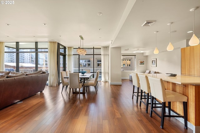 311 NW 12th Ave Unit 602, Portland, OR 97209 - dining space featuring dark wood finished floors, a wall of windows, and baseboards