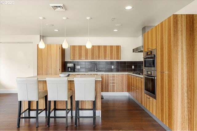 311 NW 12th Ave Unit 602, Portland, OR 97209 - kitchen with modern cabinets, decorative backsplash, a sink, and recessed lighting