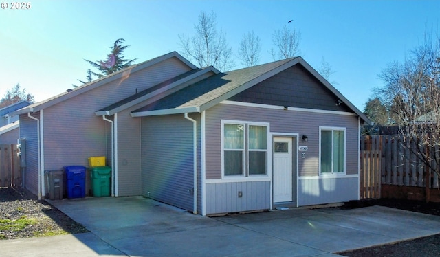 back of house with fence