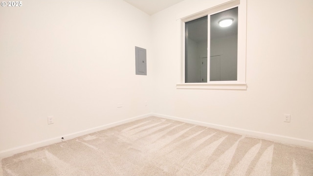 empty room featuring carpet and electric panel