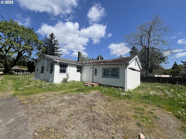 view of front of property featuring fence and a chimney
