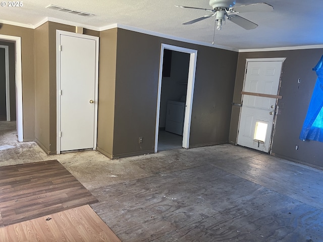 interior space with a ceiling fan, washer / dryer, ornamental molding, and visible vents